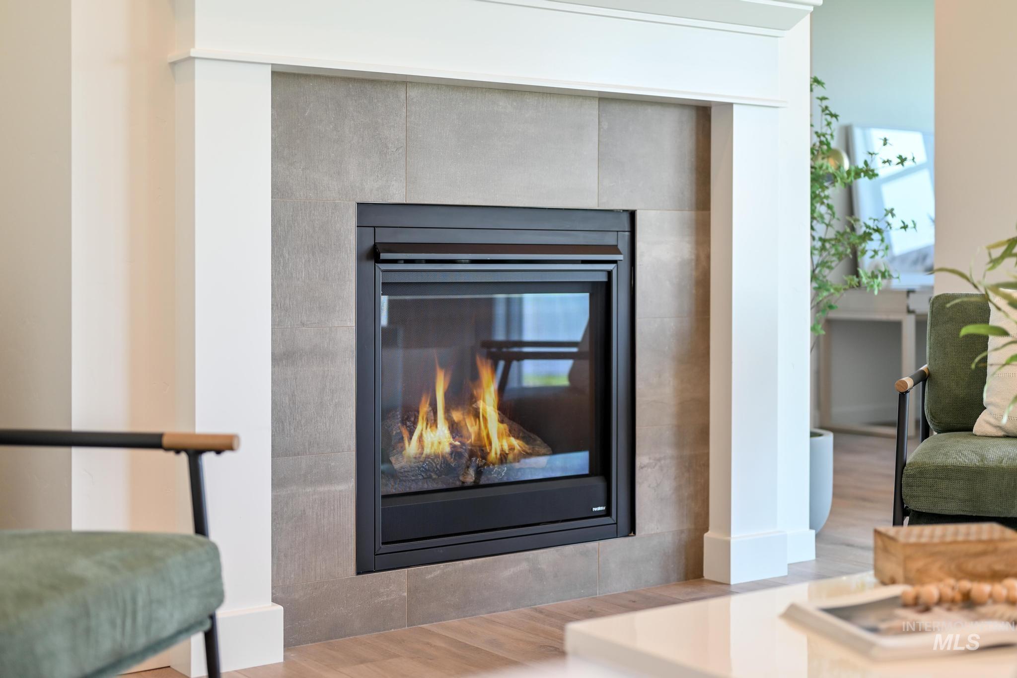 Detailed view of a tile fireplace and wood finished floors