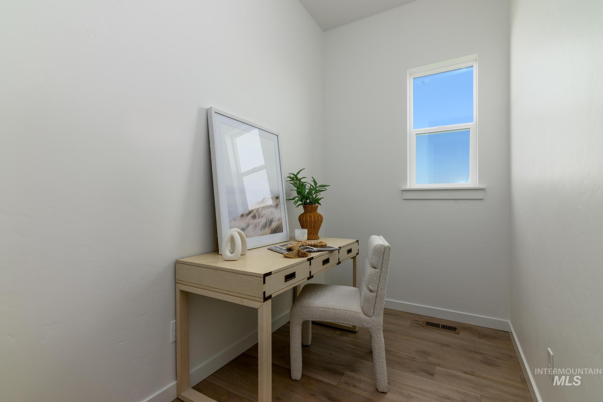 Office space featuring baseboards and wood finished floors