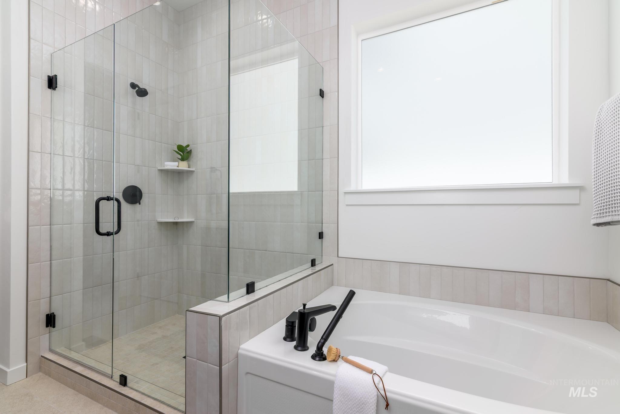 Bathroom featuring a garden tub and a stall shower