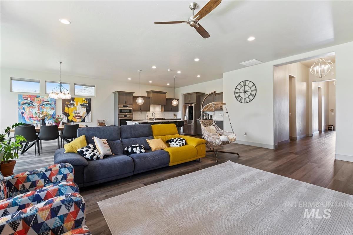 Open-concept living area featuring wood-finish flooring, recessed lighting, and a ceiling fan