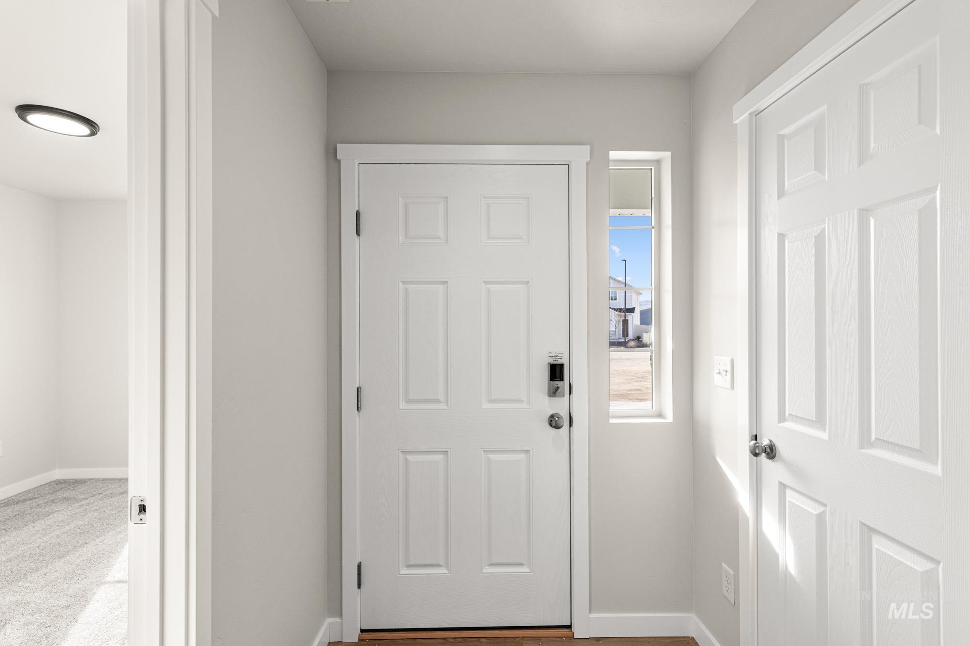 Doorway featuring baseboards