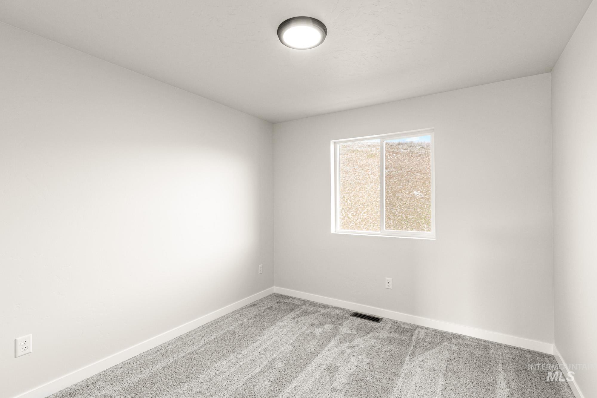 Unfurnished room featuring light colored carpet and baseboards