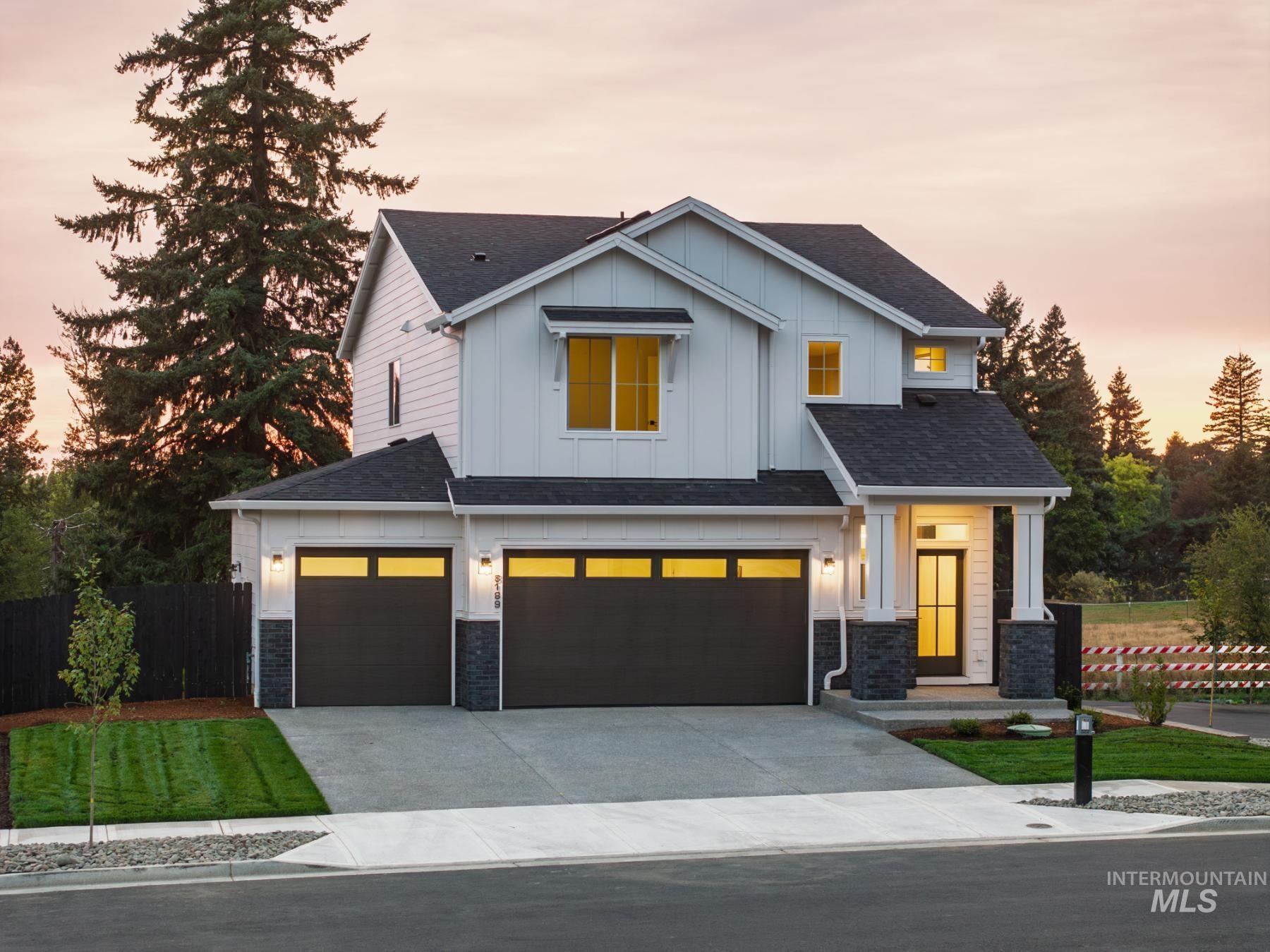 View of front of house featuring an attached garage, board and batten siding, driveway, and roof with shingles