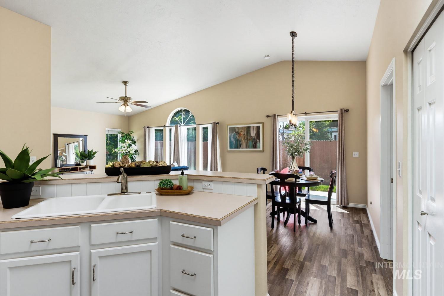 Kitchen with white cabinetry, a double basin sink, and laminate countertops