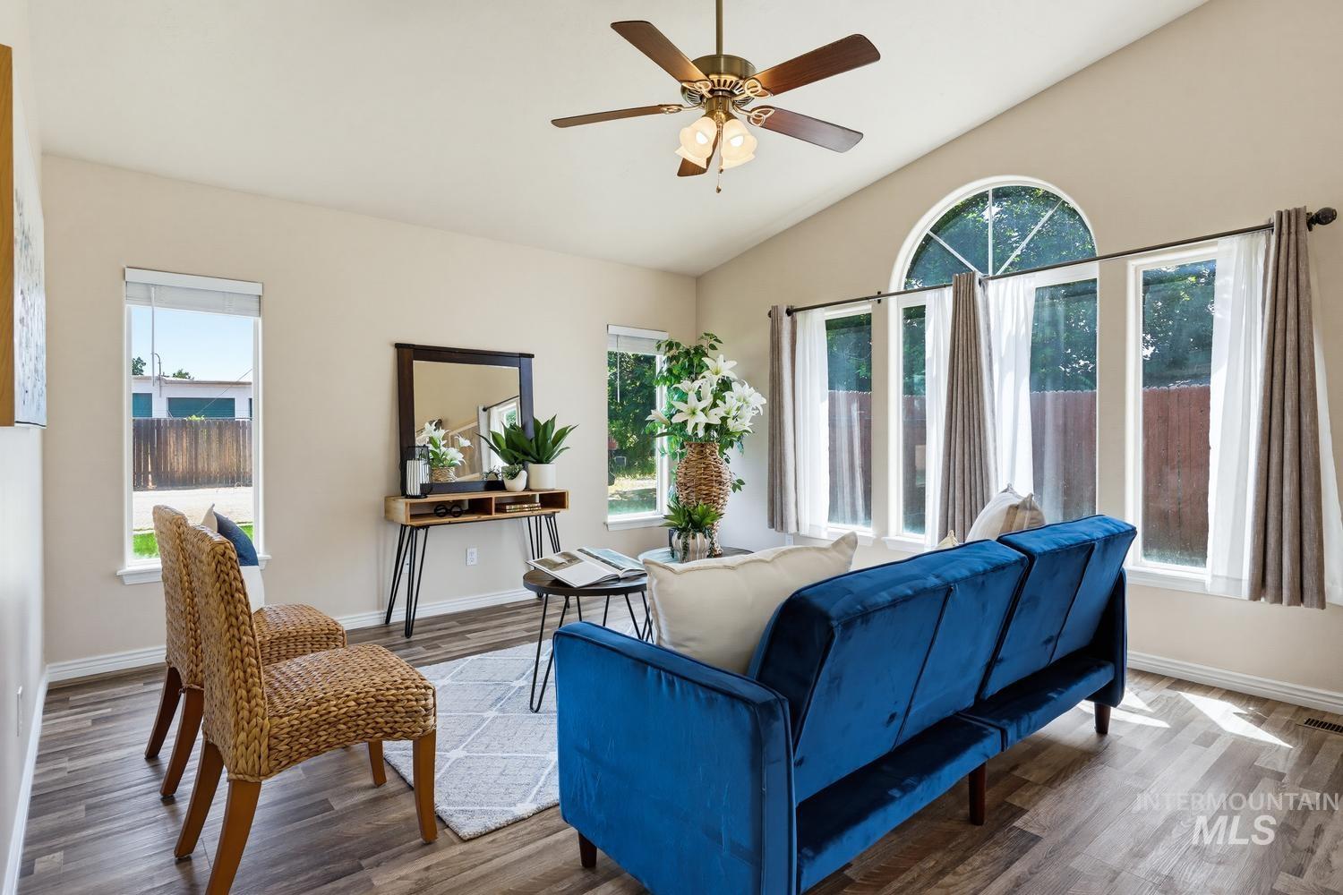 Vaulted ceilings featuring a ceiling fan with integrated lighting