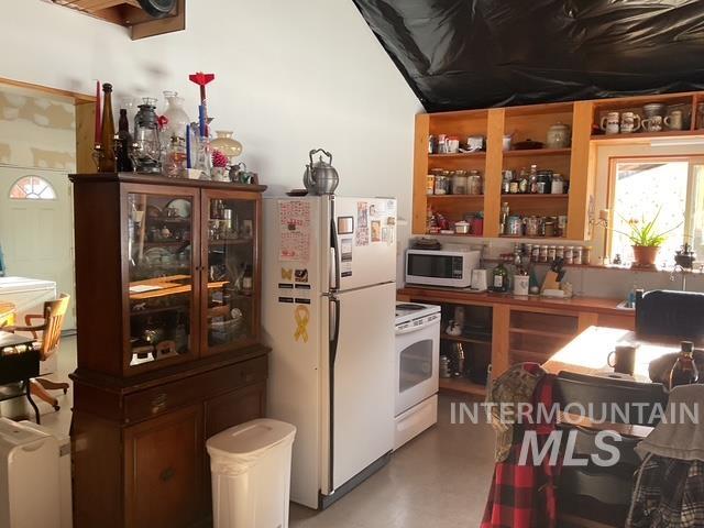 Kitchen with white appliances and open shelves