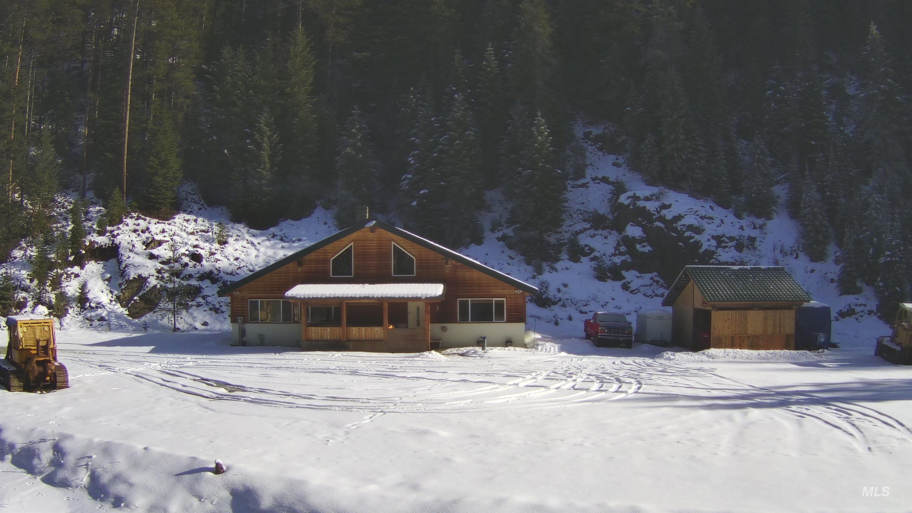Chalet / cabin featuring an outbuilding and a sunroom