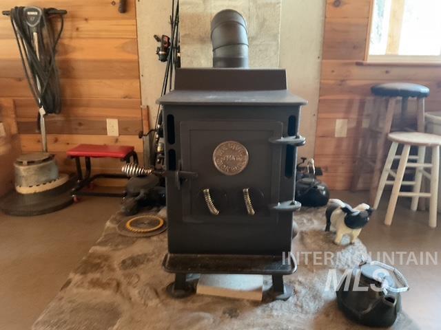 Detailed view of wooden walls, a heating unit, and a wood stove