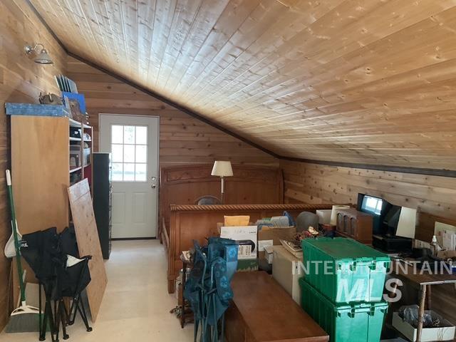 Bonus room with wood walls, wooden ceiling, and lofted ceiling