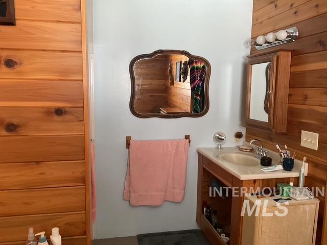 Bathroom featuring vanity and wooden walls