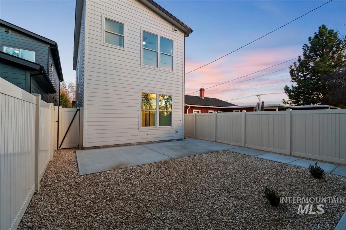 Back of property featuring a patio and a fenced backyard