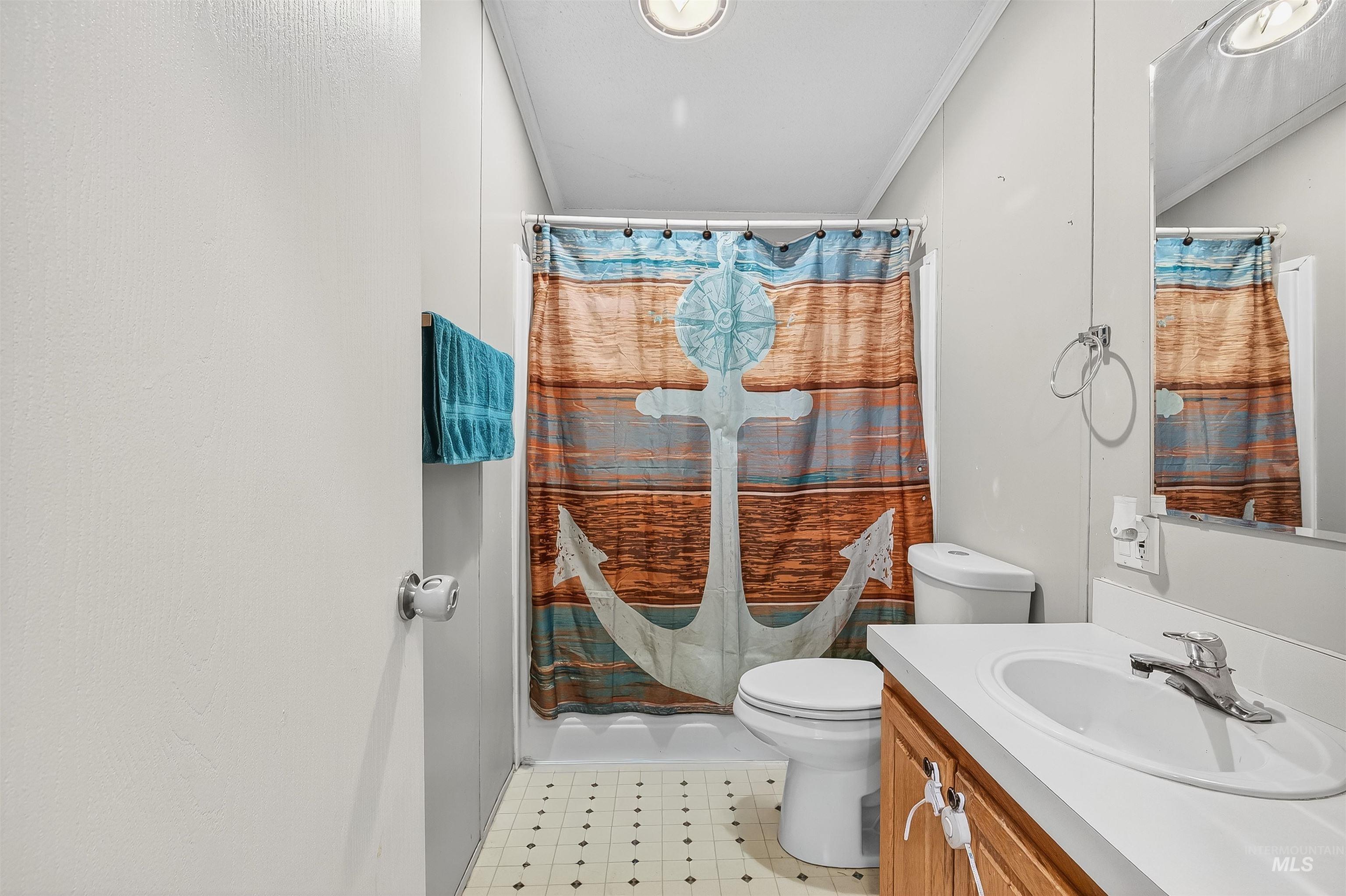 Bathroom with vanity, a stall shower, and crown molding