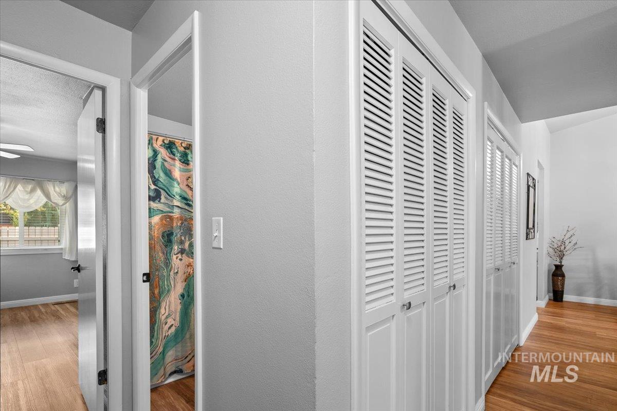 Hallway with light wood finished floors and baseboards