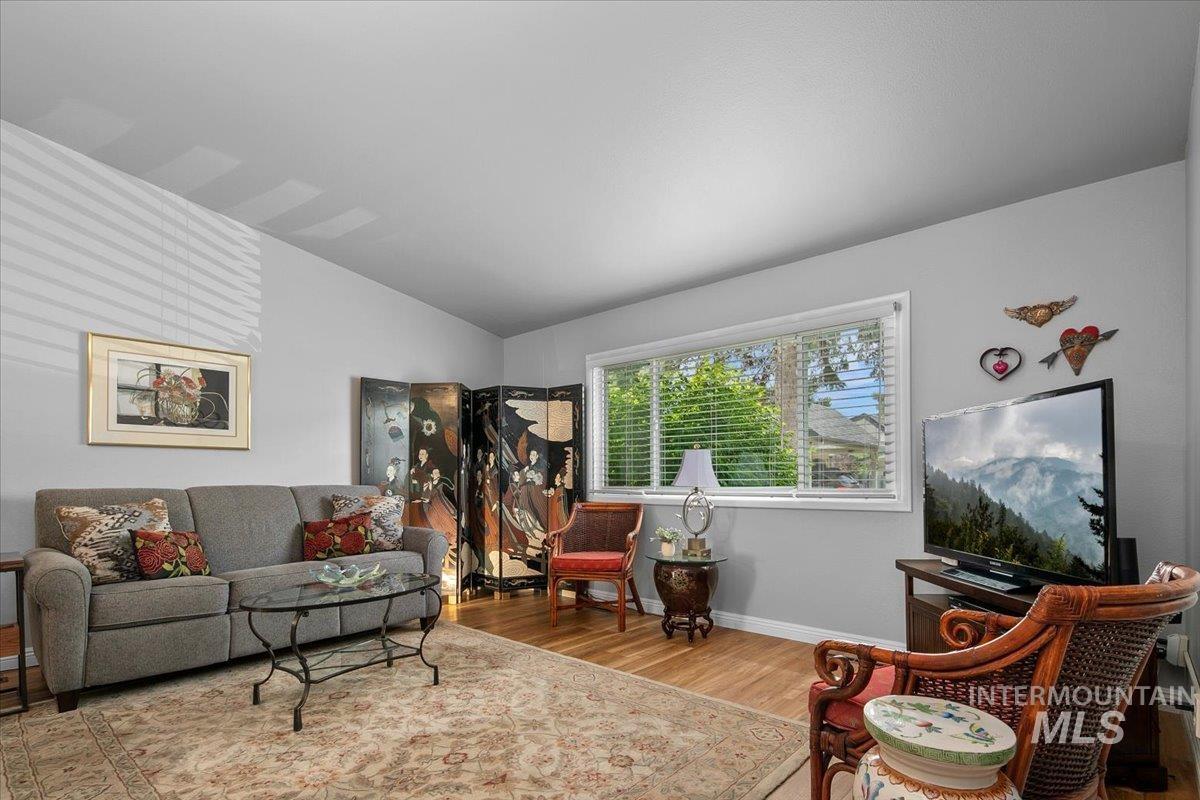 Living area featuring wood finished floors and lofted ceiling