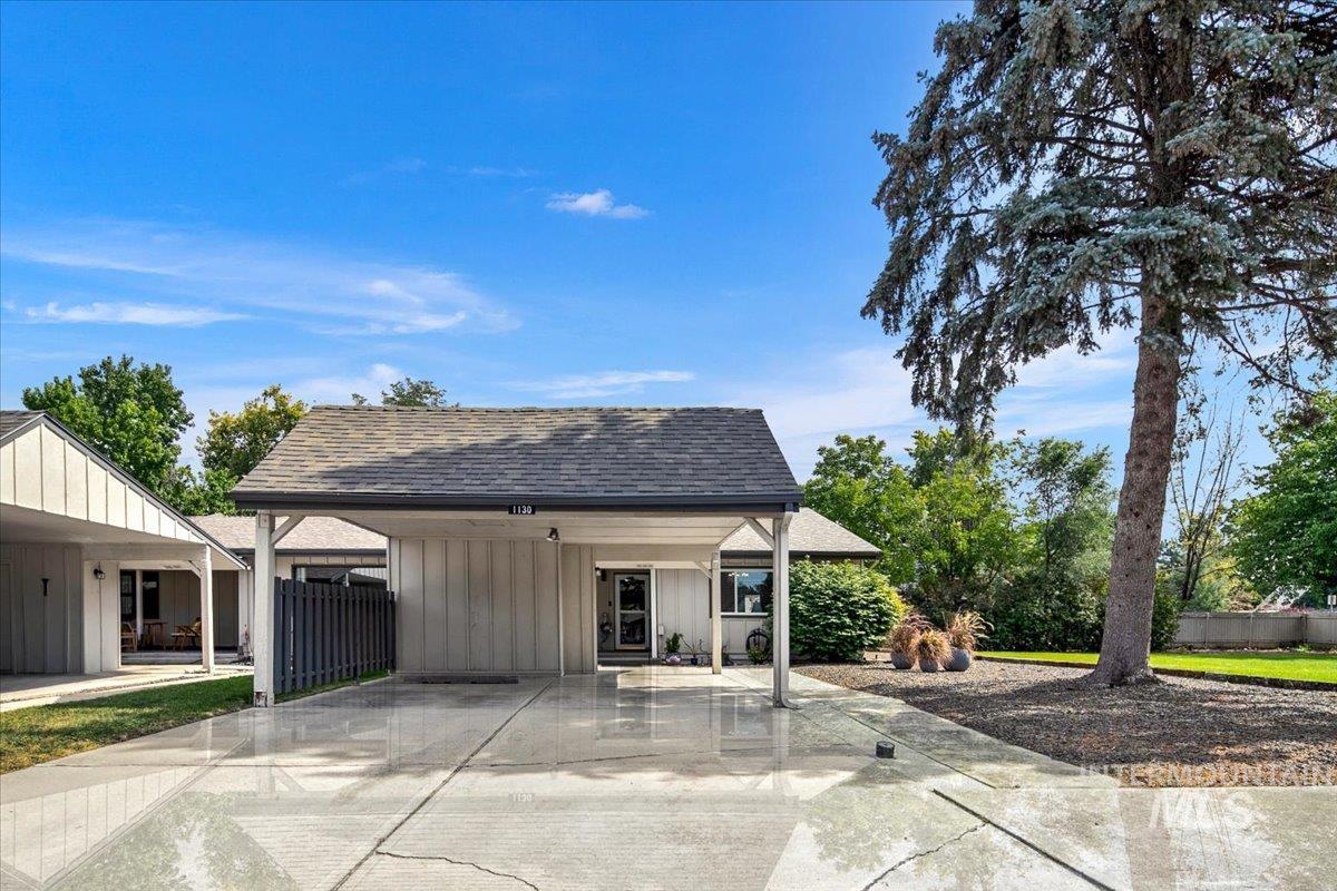 View of home's exterior with roof with shingles and a patio area