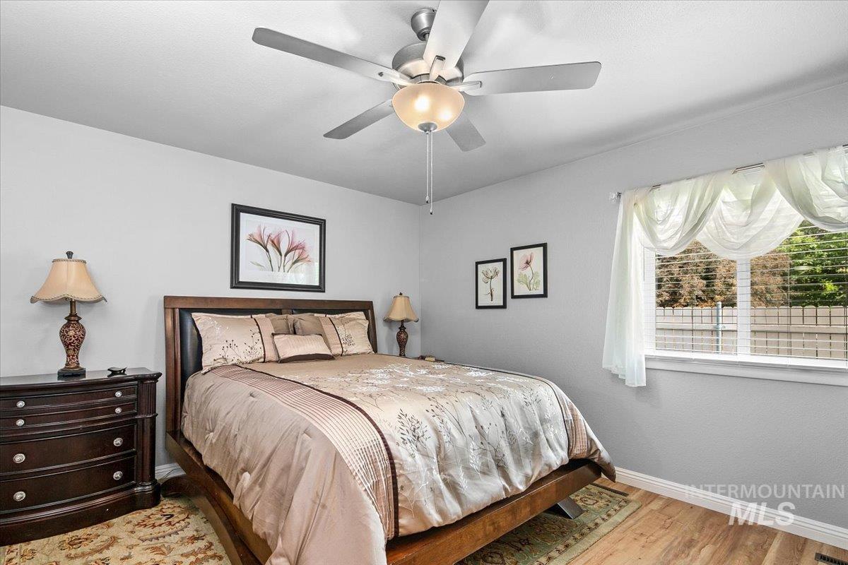Bedroom with wood finished floors and ceiling fan