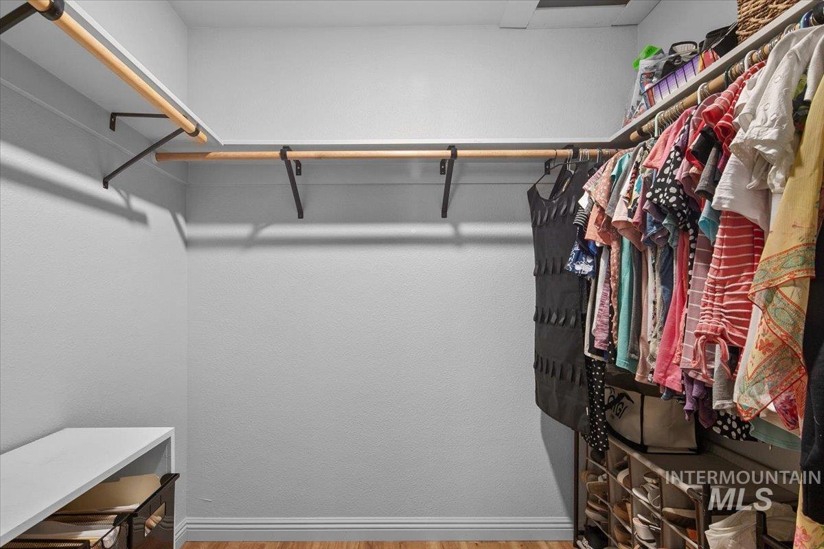 Spacious closet with light wood finished floors