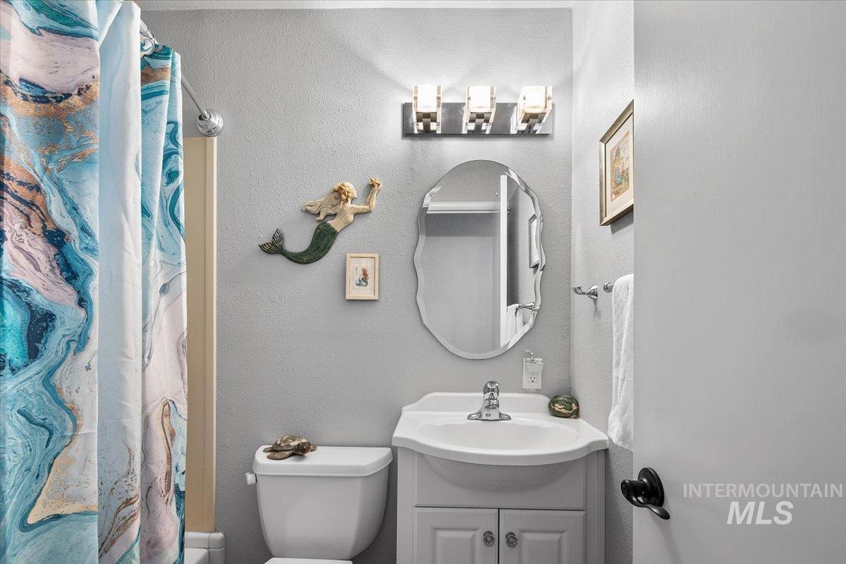 Bathroom with vanity and a textured wall