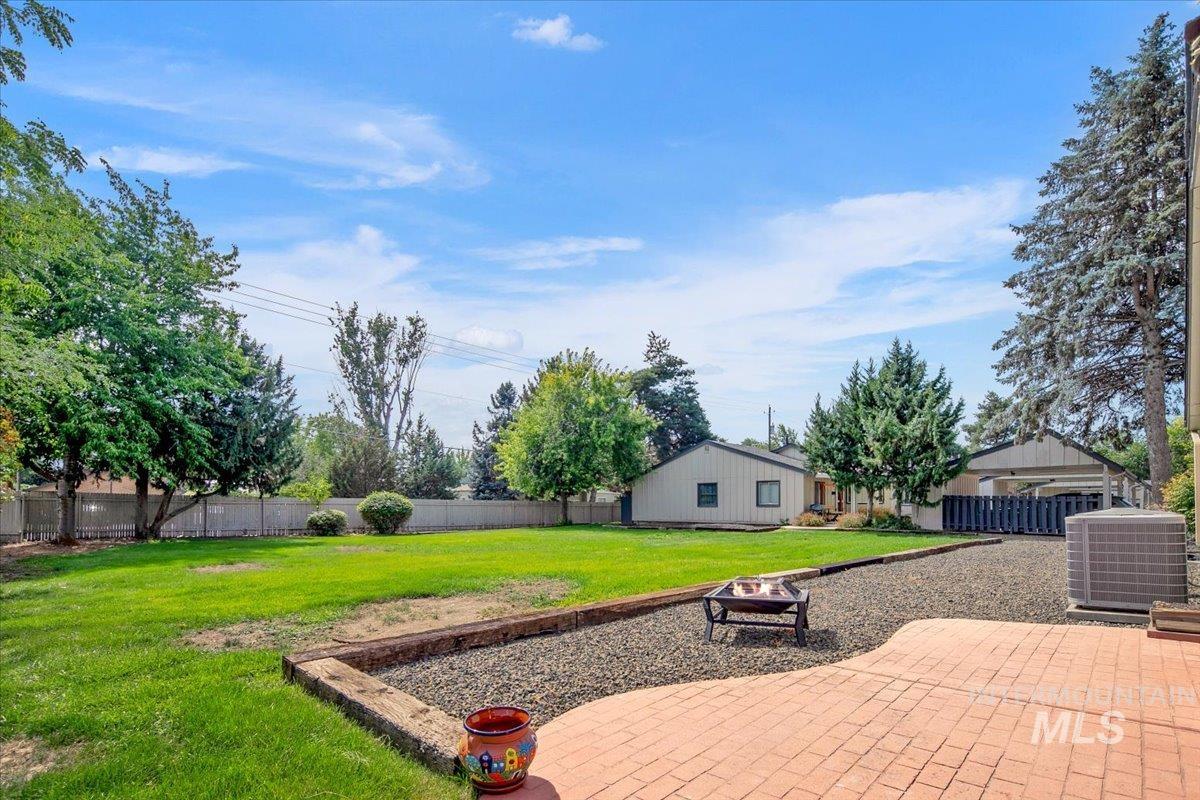 Fenced backyard with a patio area and a fire pit