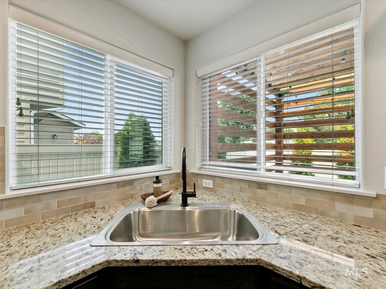 Kitchen featuring light stone countertops