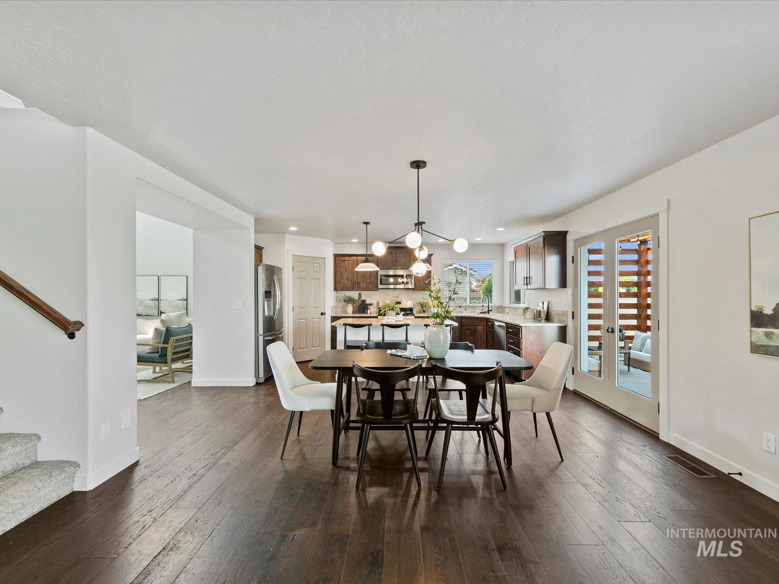 Dining space featuring stairway, dark wood-style flooring, and recessed lighting
