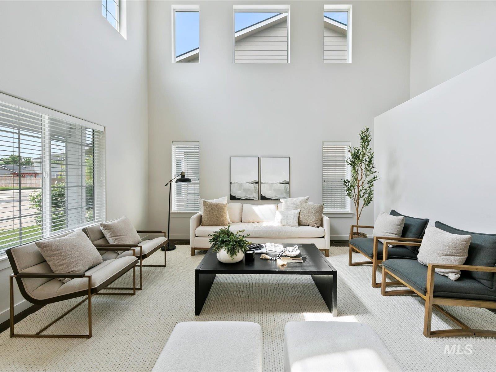 Living area with a high ceiling and baseboards