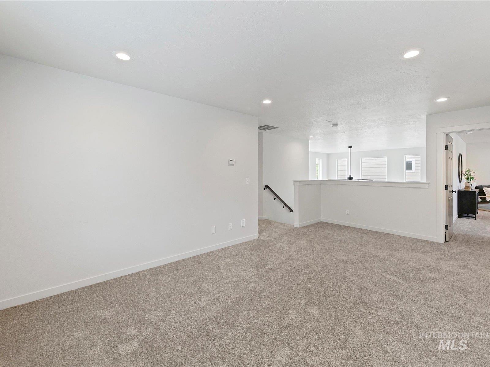 Unfurnished room with light carpet and recessed lighting