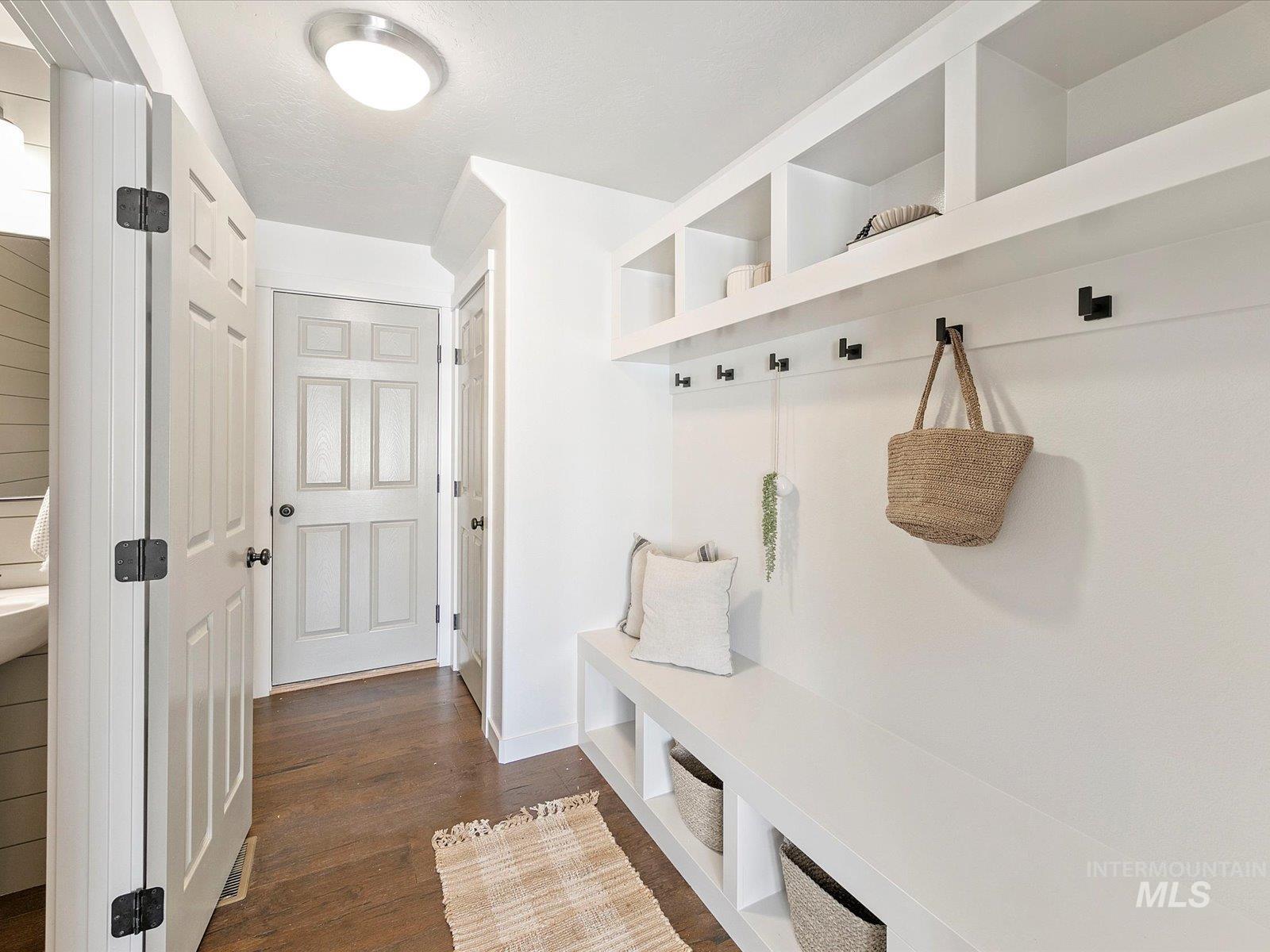 Mudroom featuring dark wood-type flooring