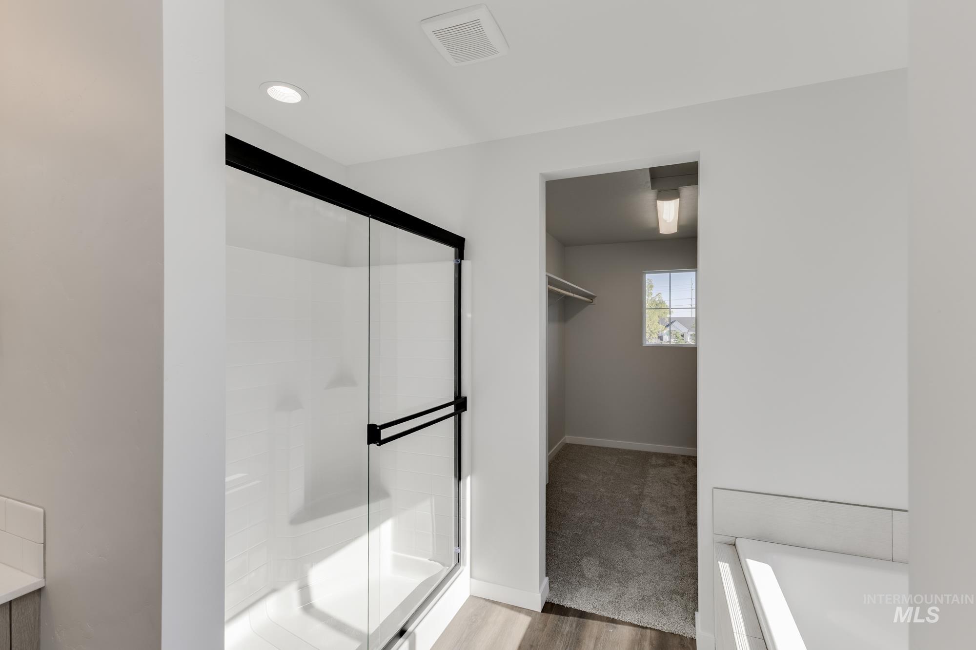 Bathroom featuring a stall shower and light wood-style flooring