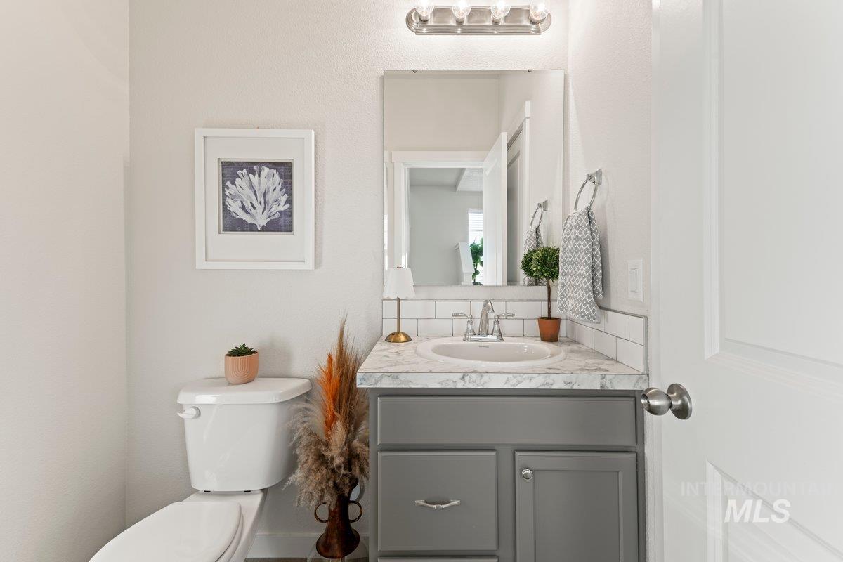 Bathroom featuring vanity and backsplash