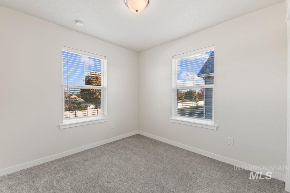 Carpeted spare room with plenty of natural light