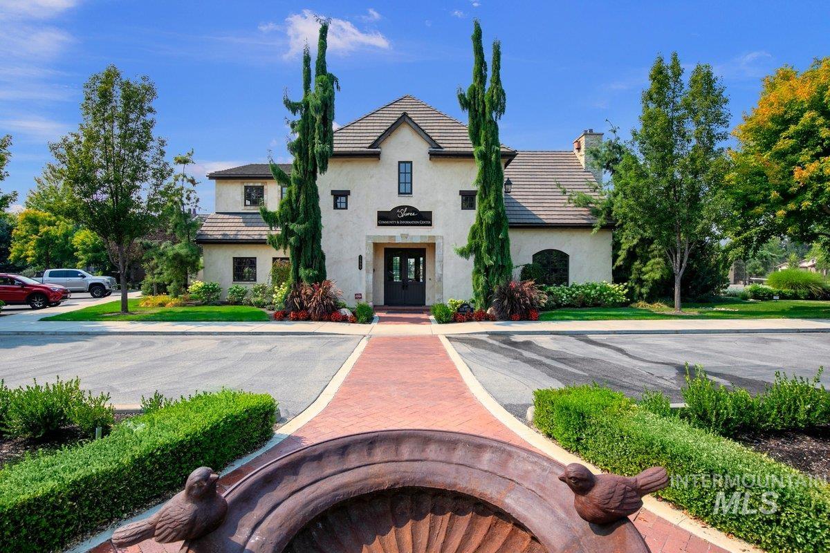 View of front of house featuring a chimney, stucco siding, and french doors
