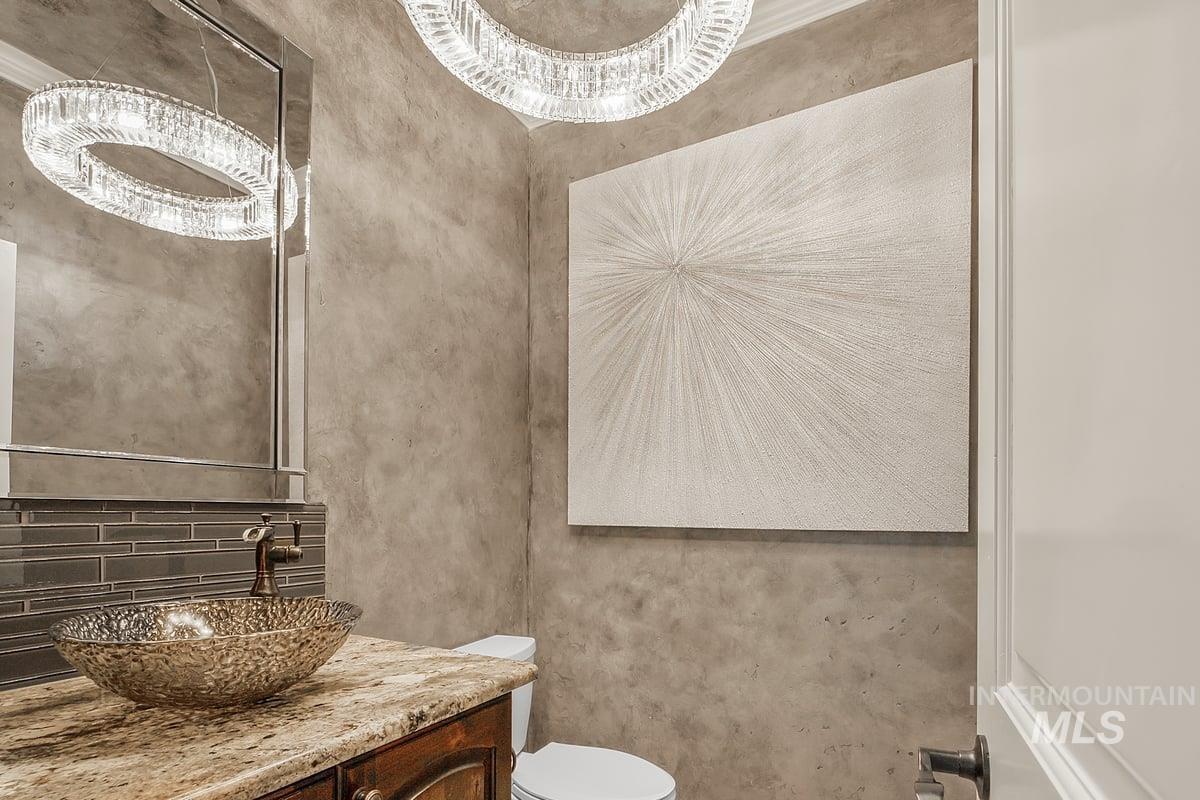Bathroom featuring vanity and backsplash