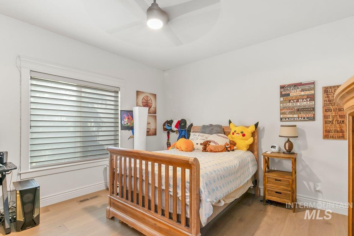Bedroom featuring light wood-style floors and a ceiling fan