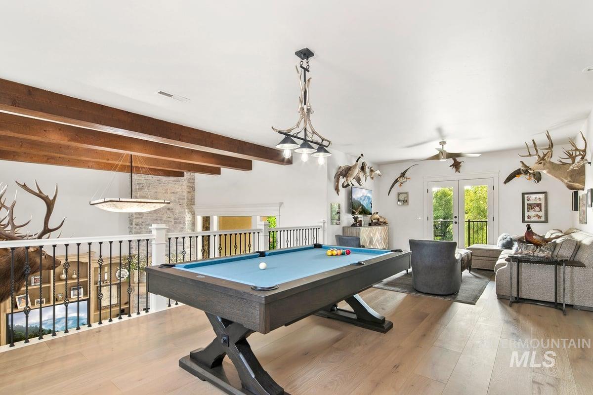 Rec room featuring pool table, wood finished floors, beamed ceiling, french doors, and ceiling fan