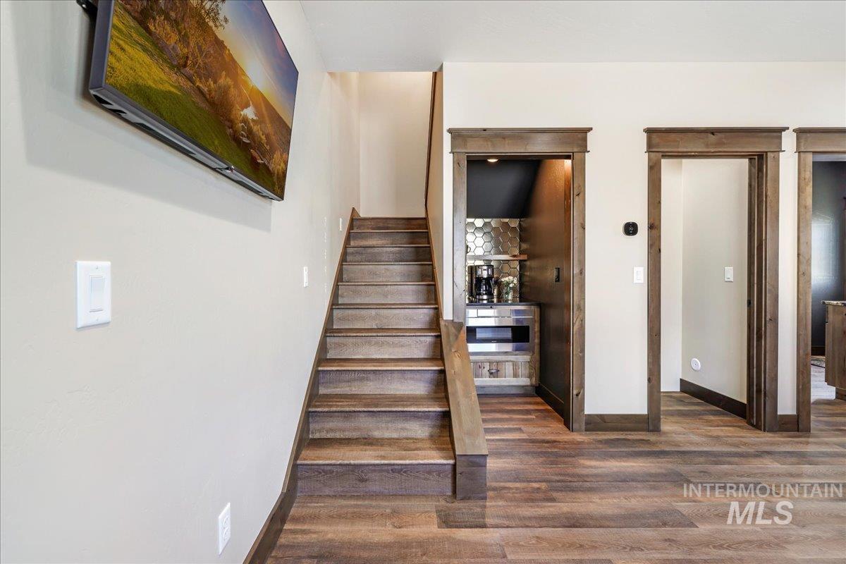 Stairs featuring wood finished floors and baseboards