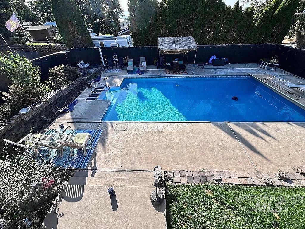 Rectangular inground swimming pool with integrated steps and a pool cover