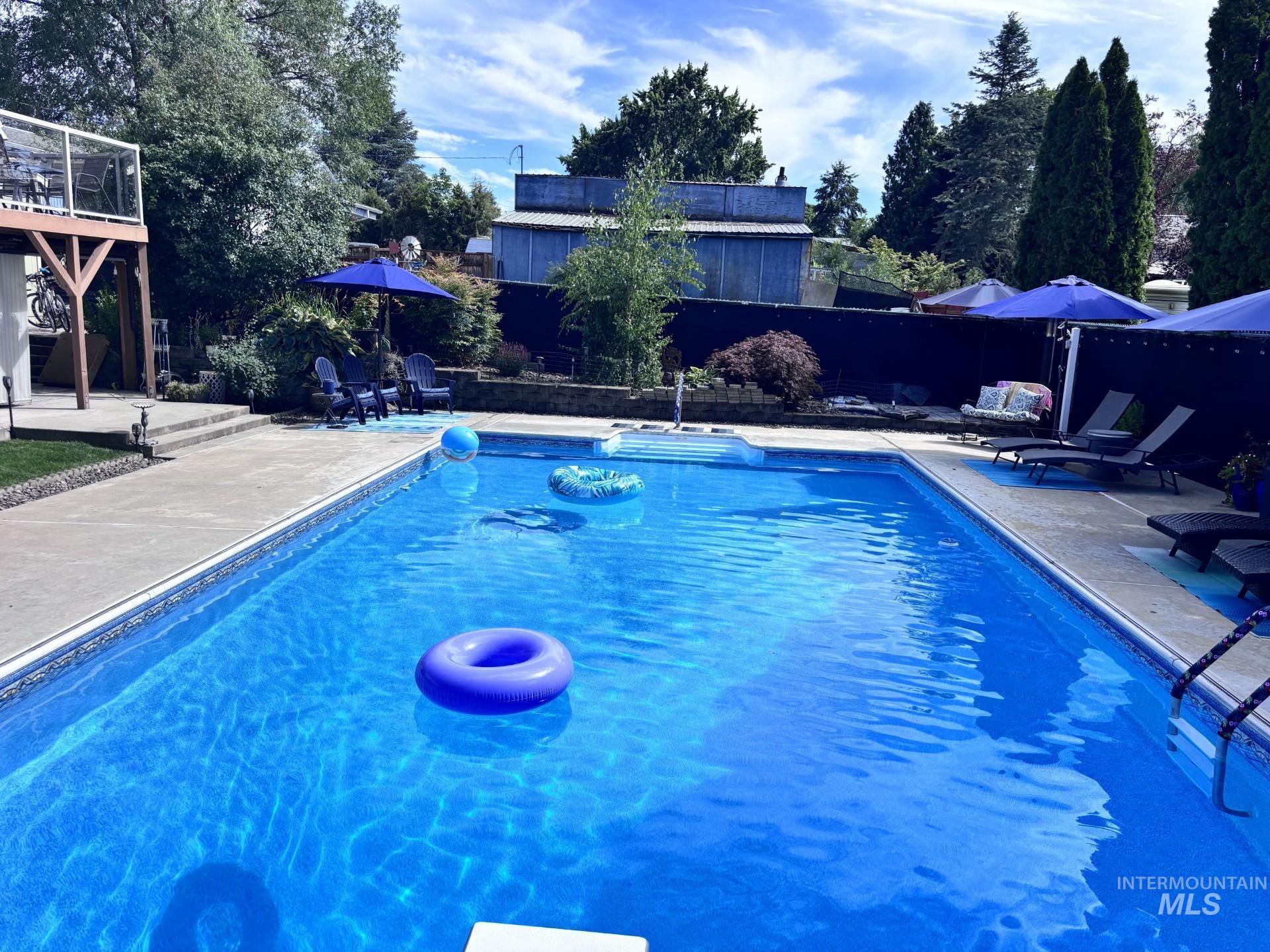 In-ground swimming pool featuring a concrete surround