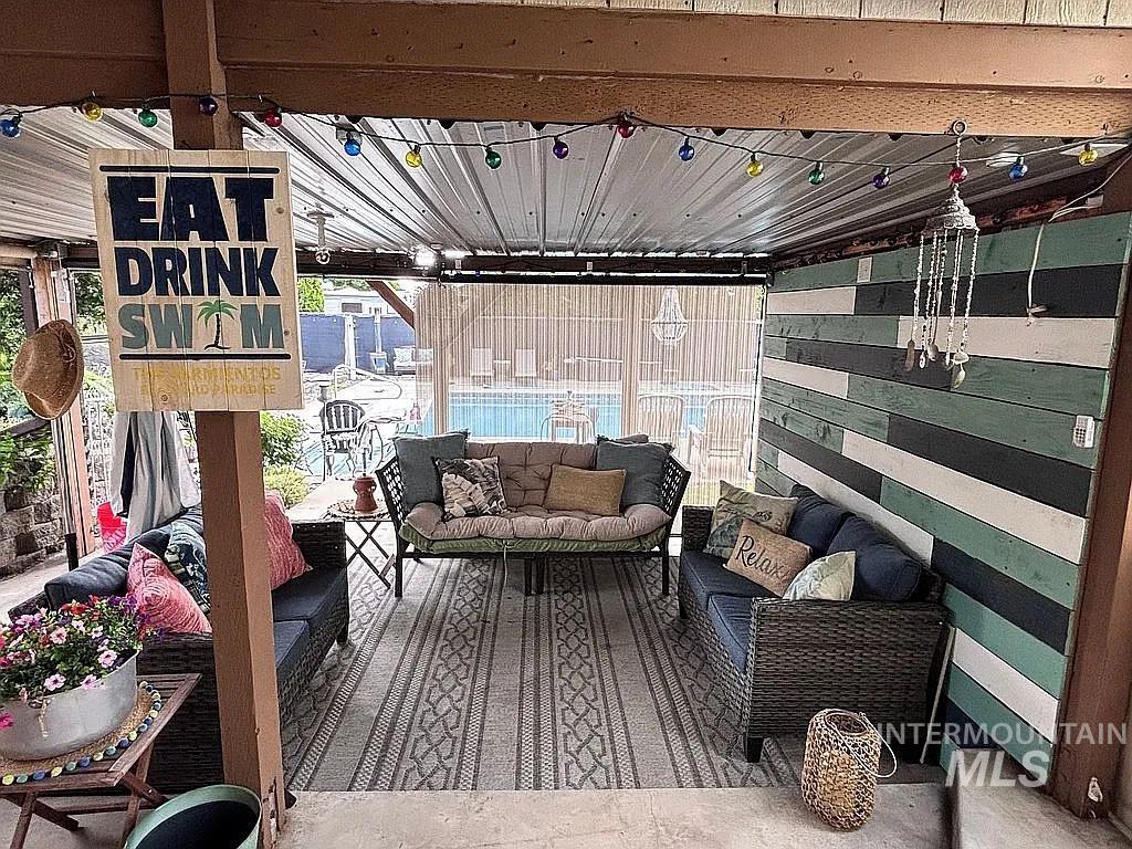 Covered patio featuring a corrugated metal roof and string lighting