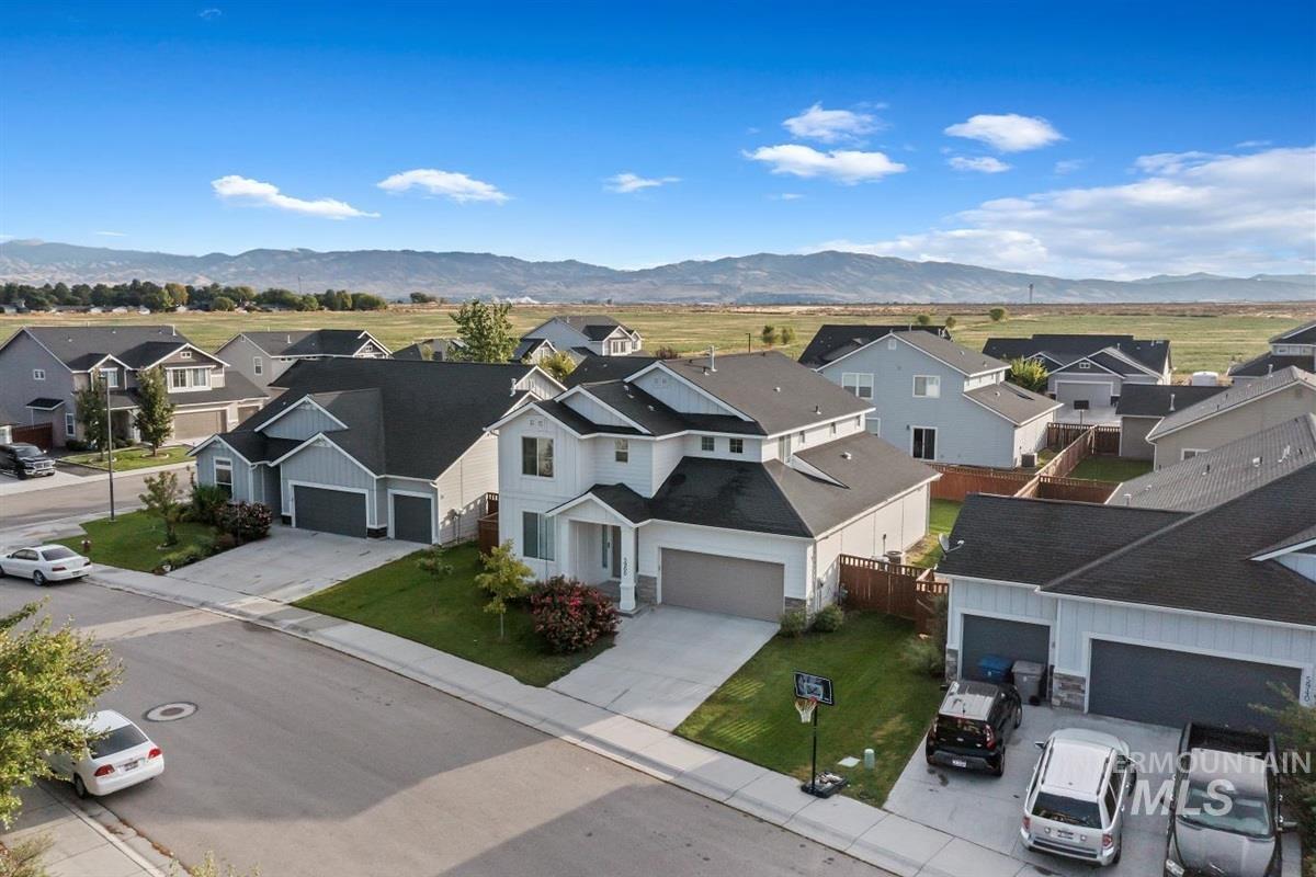 Aerial perspective of suburban area featuring a mountain backdrop