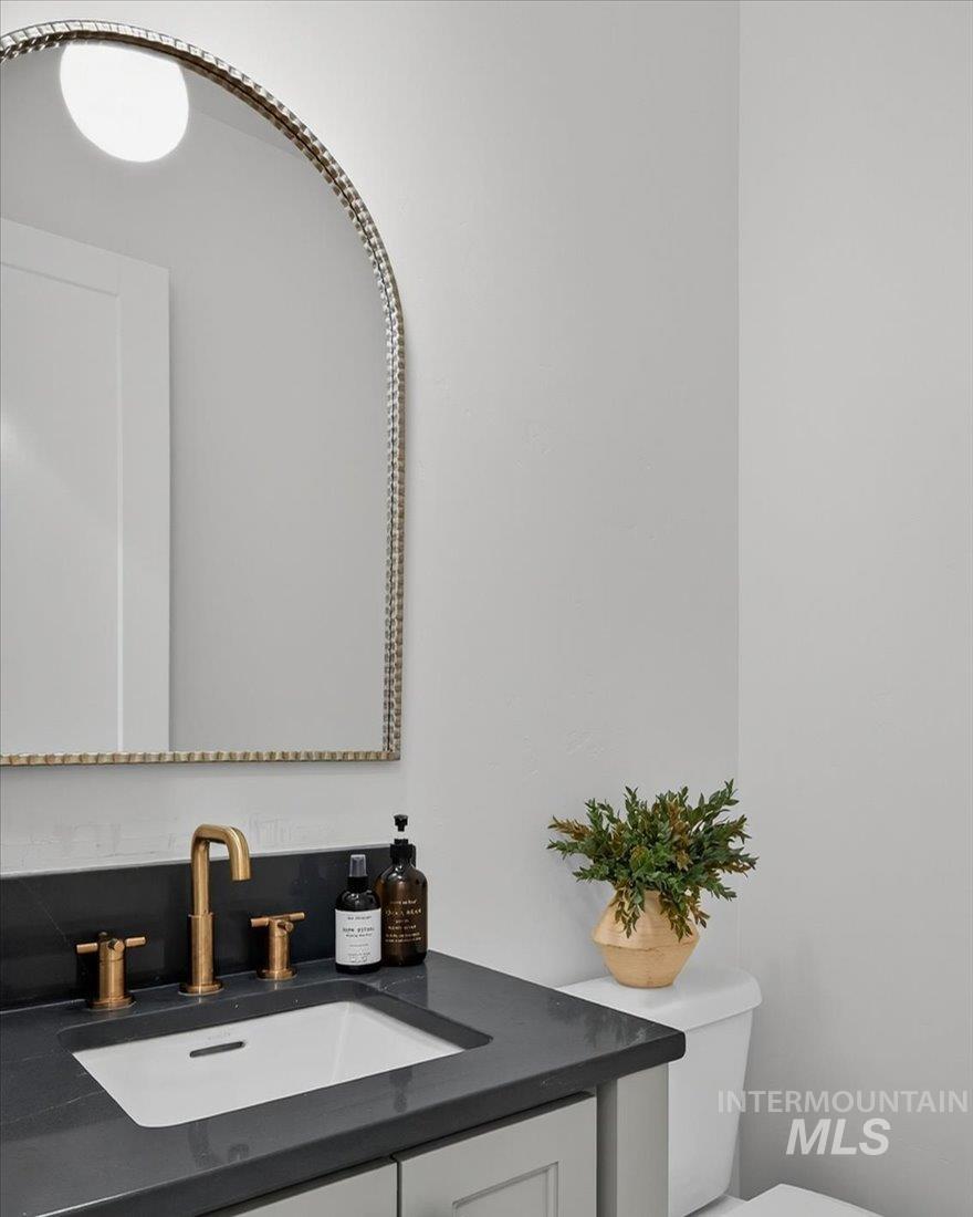 Half bath featuring vanity and toilet