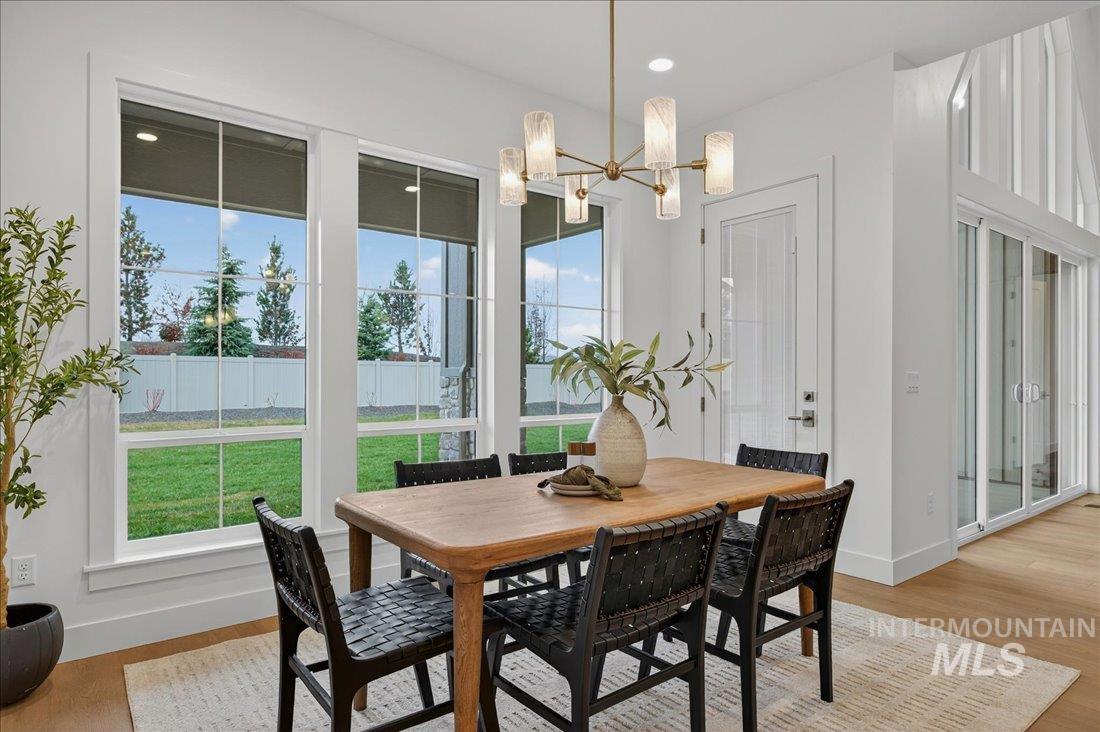 Dining area with light wood-style floors, a chandelier, and recessed lighting