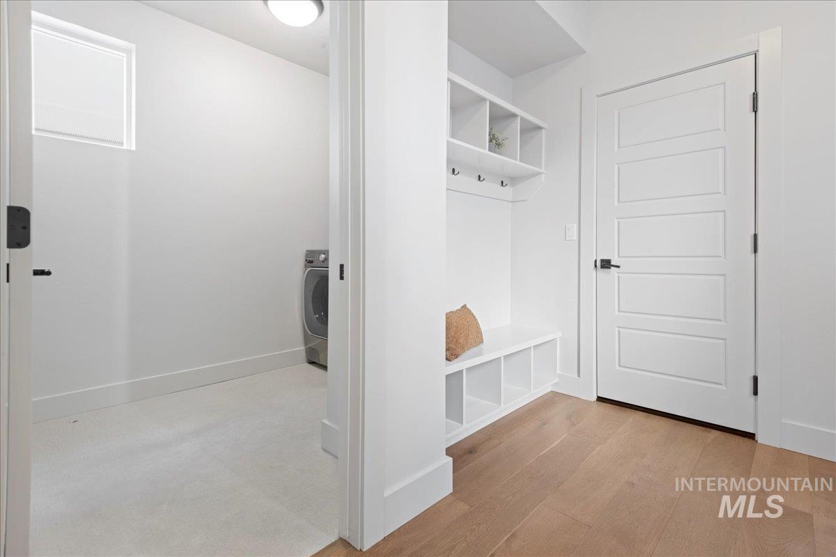 Mudroom featuring light wood finished floors and washer / dryer