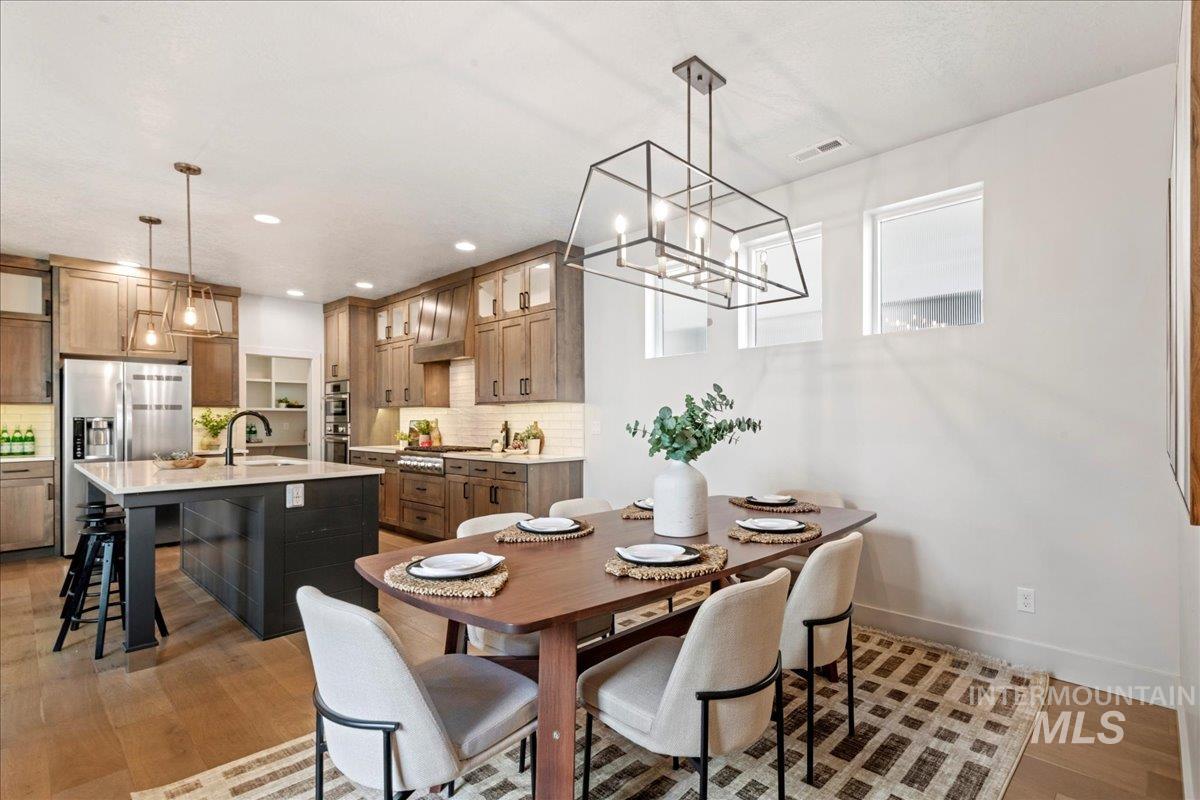 Dining room featuring light wood finished floors and recessed lighting