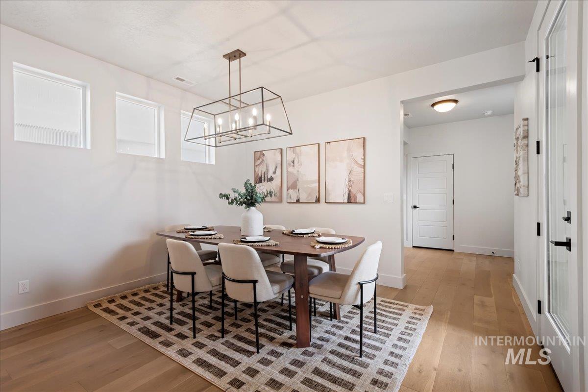 Dining space featuring light wood-style floors and baseboards