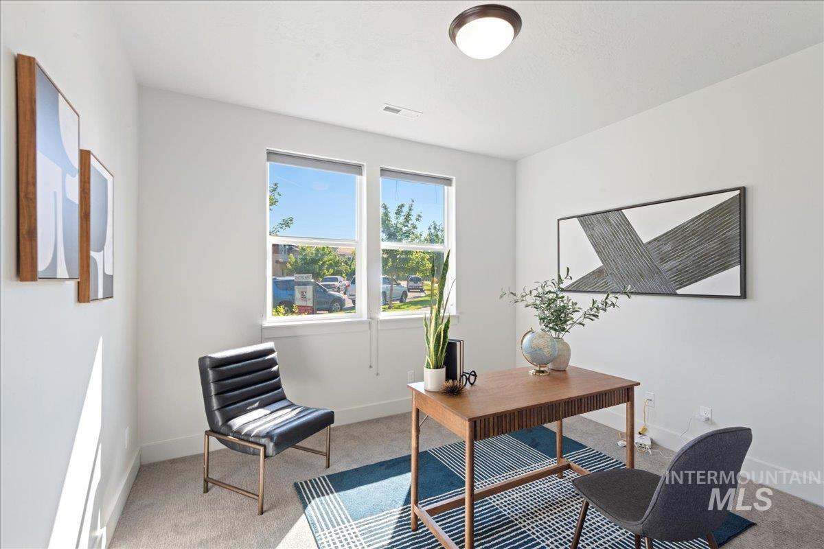 Office space featuring light colored carpet and baseboards