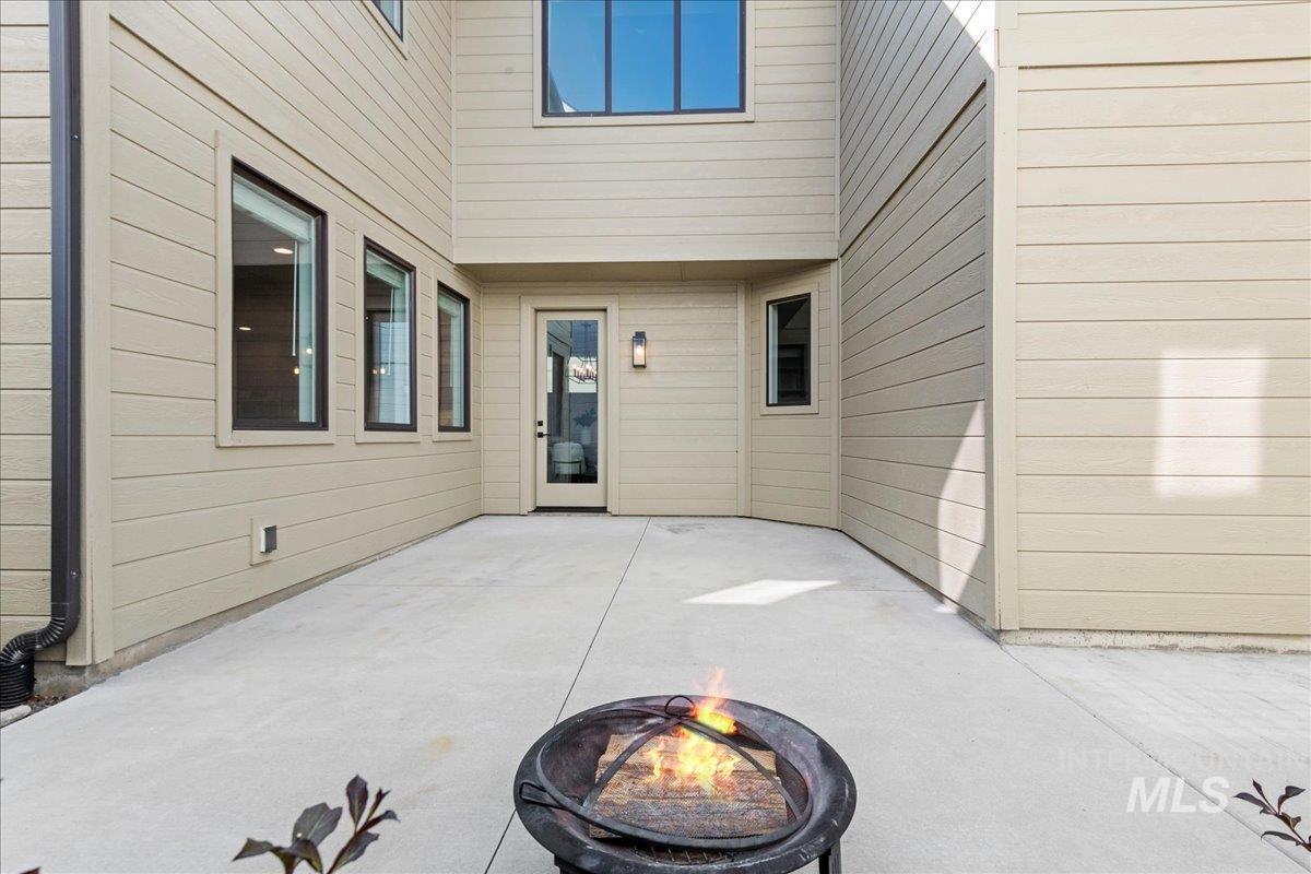 View of patio with an outdoor fire pit