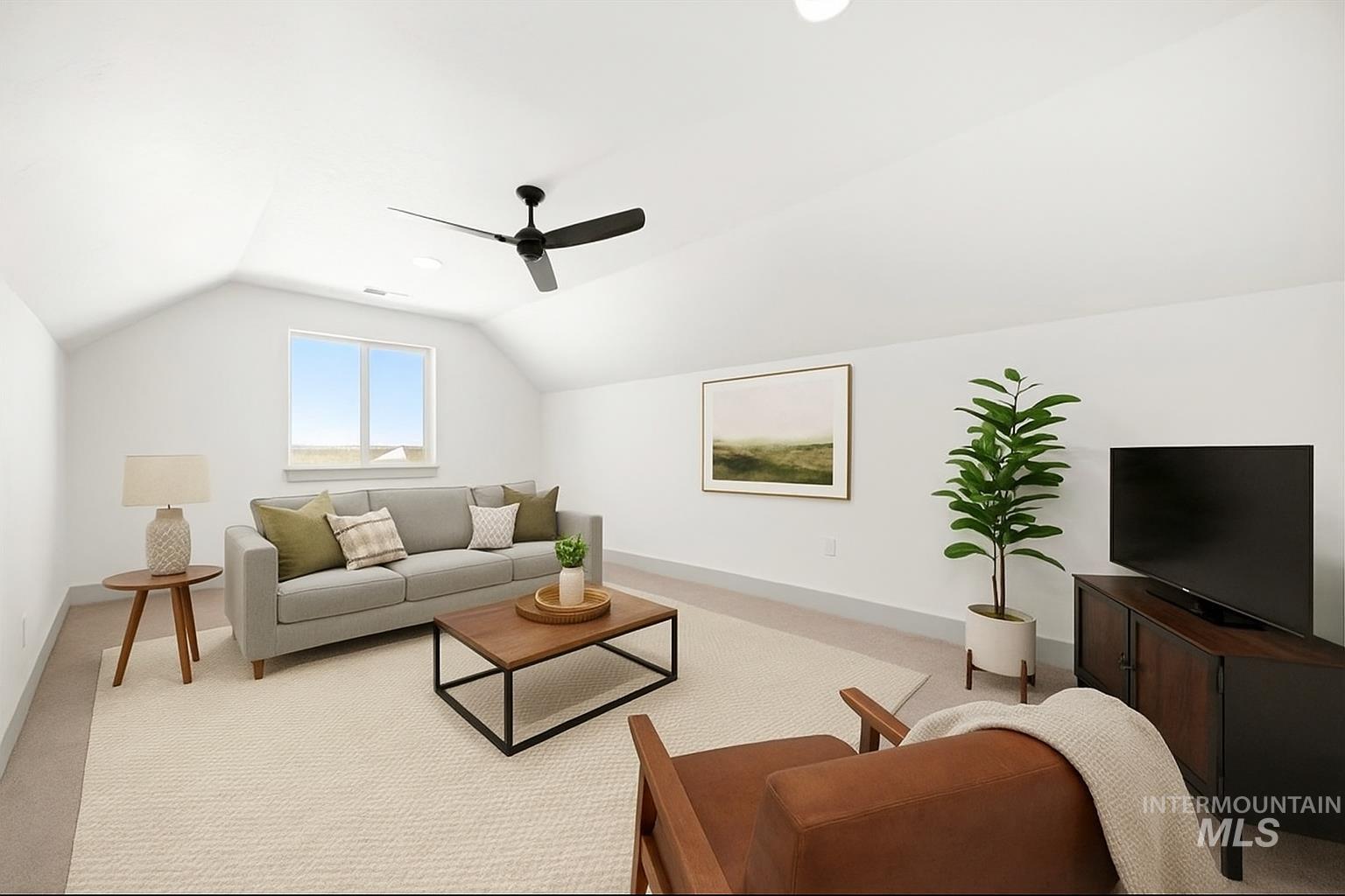 Living area featuring lofted ceiling, carpet flooring, and a ceiling fan