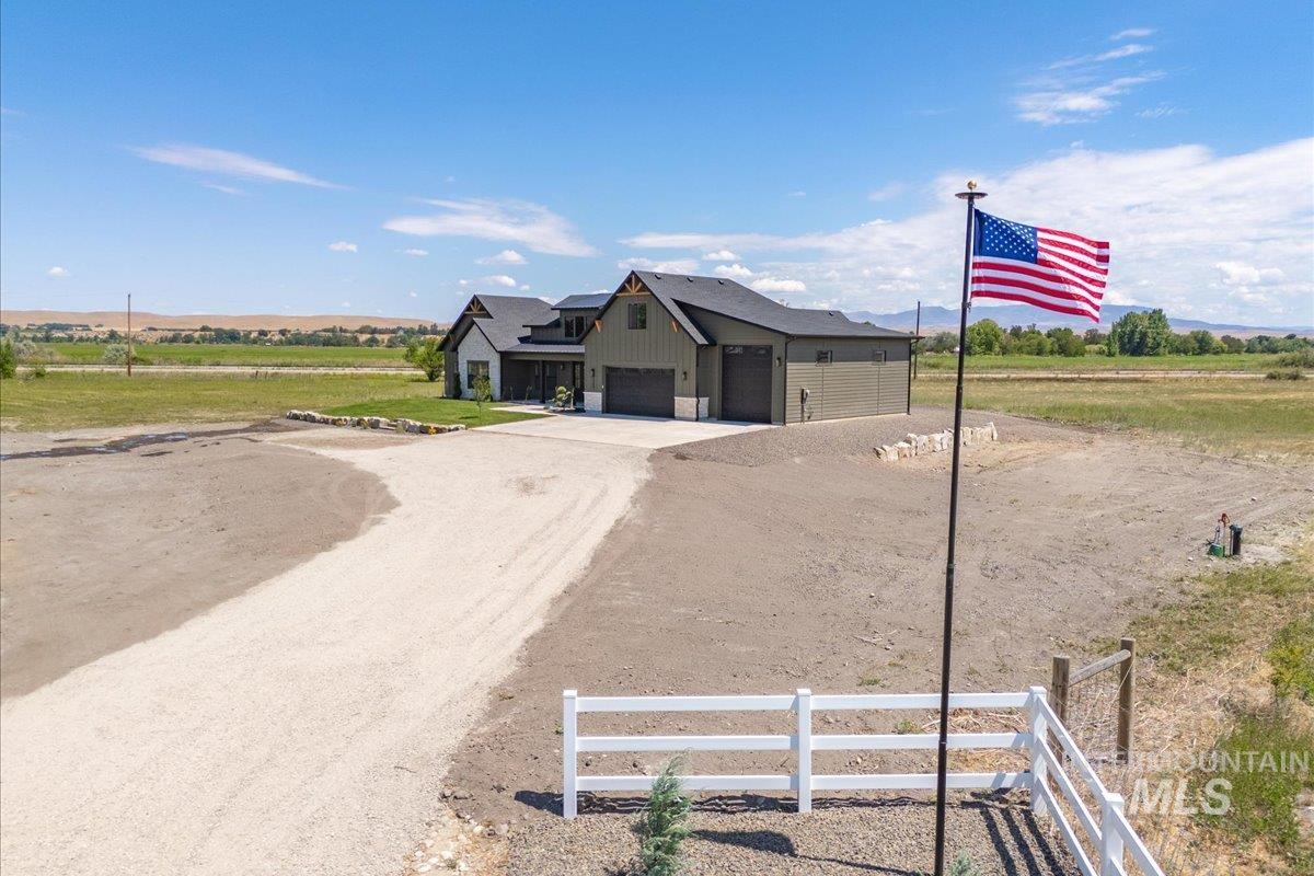 View of dirt / gravel road with a view of rural / pastoral area