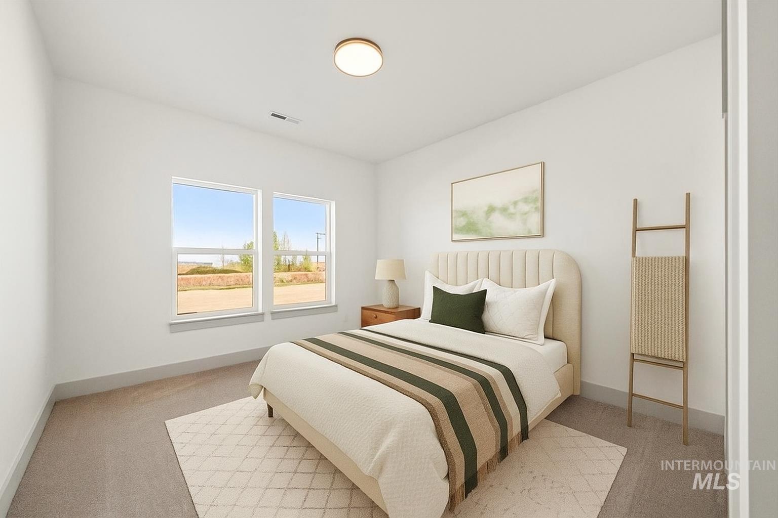 Bedroom with light colored carpet and baseboards